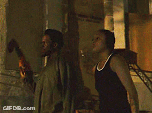 Man And Woman Standing In Front Of Building GIF