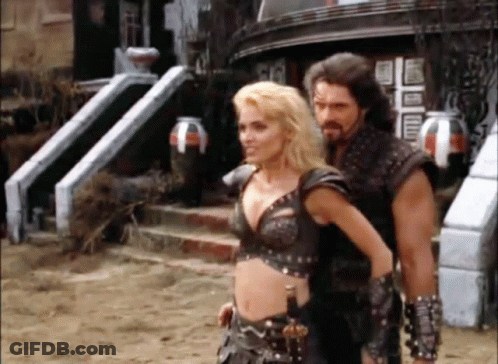 Man And Woman Standing In Front Of Building GIF