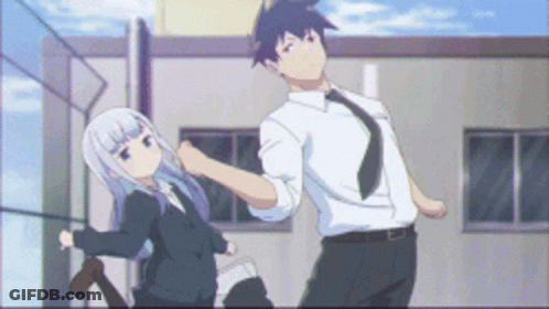 Man And Woman Standing In Front Of Building GIF