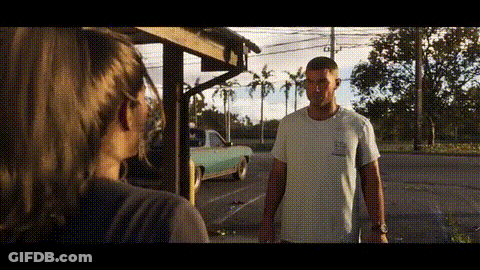Man And Woman Standing In Front Of Building GIF