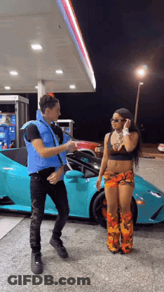 Man And Woman Standing In Front Of Car At Gas Station GIF
