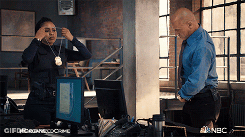 Man And Woman Standing In Front Of Computer With NBC Logo GIF
