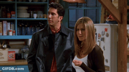 Man And Woman Standing In Front Of Fridge GIF
