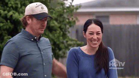 Man And Woman Standing In Front Of HGTV House GIF