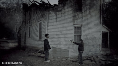 Man And Woman Standing In Front Of House GIF