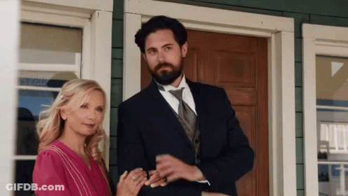Man And Woman Standing In Front Of House GIF
