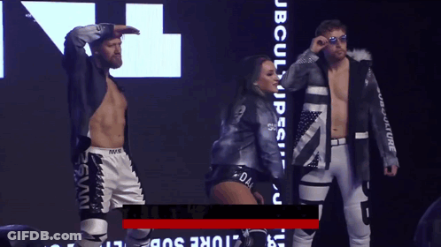 Man And Woman Standing In Front Of JB Culture Sign GIF