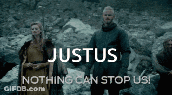 Man And Woman Standing In Front Of Justus Sign GIF