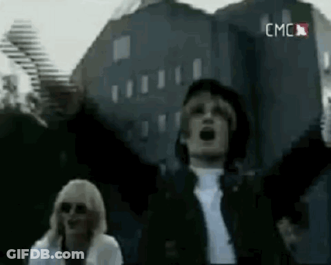 Man And Woman Standing In Front Of Large Building GIF