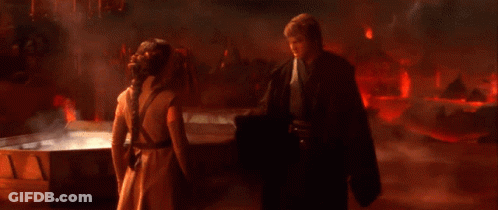 Man And Woman Standing In Front Of Red Fire GIF