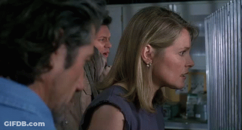 Man And Woman Standing In Front Of Refrigerator GIF