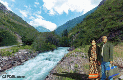 Man And Woman Standing In Front Of River GIF