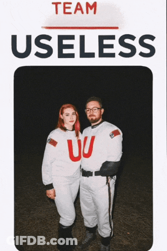 Man And Woman Standing In Front Of Team Useless Sign GIF