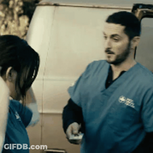 Man And Woman Standing In Front Of Van GIF