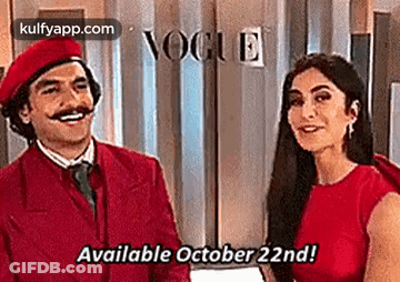 Man And Woman Standing In Front Of Vogue Sign GIF