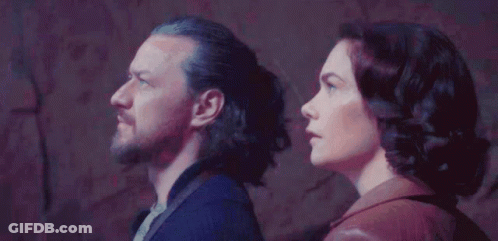 Man And Woman Standing In Front Of Wall GIF