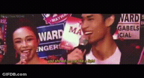 Man And Woman Standing In Front Of Ward Sign GIF