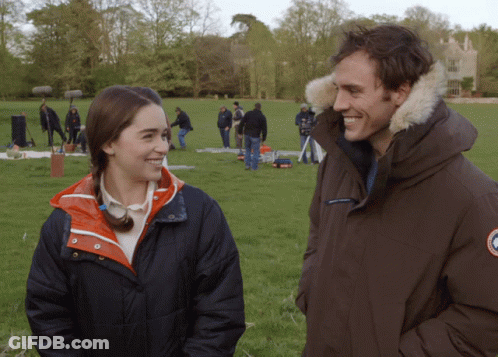 Man And Woman Standing In Grassy Field GIF