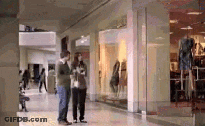 Man And Woman Standing In Mall GIF