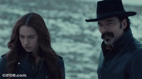 Man And Woman Standing In Snow GIF
