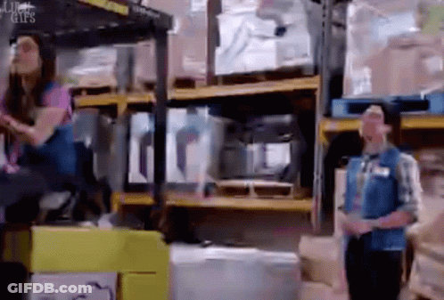 Man And Woman Standing In Warehouse GIF