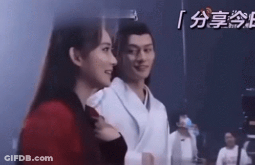 Man And Woman Standing Looking At Each Other GIF