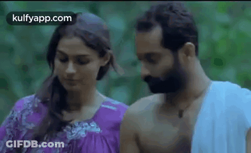 Man And Woman Standing Looking At Each Other GIF