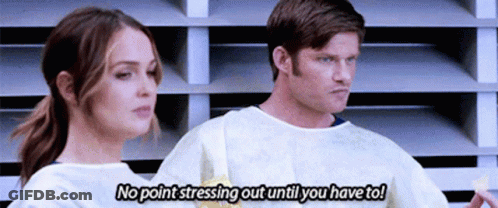 Man And Woman Standing Man Saying No Point Stressing Out Until You Have To GIF