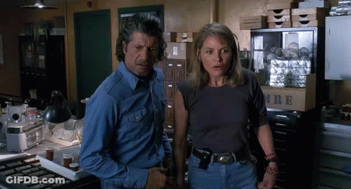Man And Woman Standing Next To Box Saying MRE GIF
