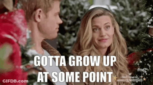 Man And Woman Standing Next To Christmas Tree GIF