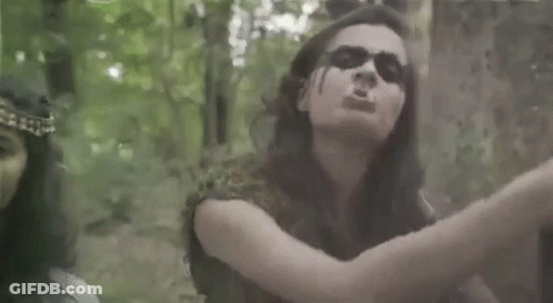 Man And Woman Standing Next To Each Other In Forest GIF