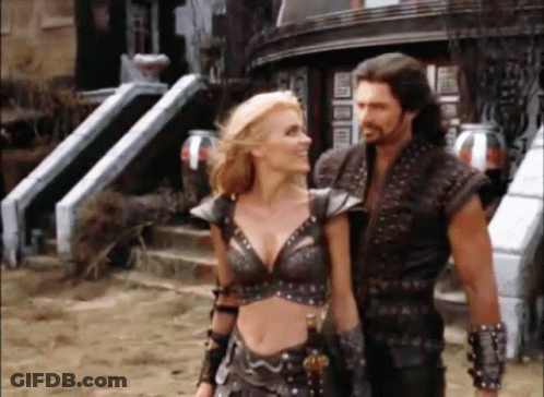 Man And Woman Standing Next To Each Other In Front Of House GIF