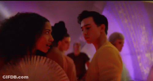 Man And Woman Standing Next To Each Other In Room GIF
