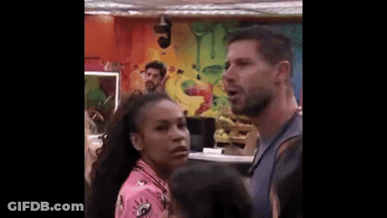 Man And Woman Standing Next To Each Other In Room With Painting GIF