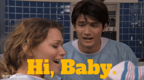 Man And Woman Standing Next To Each Other Saying Hi Baby GIF