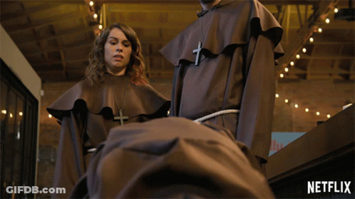 Man And Woman Standing Next To Each Other With Netflix Logo GIF