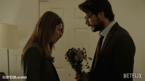 Man And Woman Standing Next To Each Other With Netflix Logo GIF