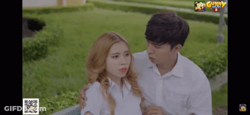 Man And Woman Standing Next To Gunny GIF