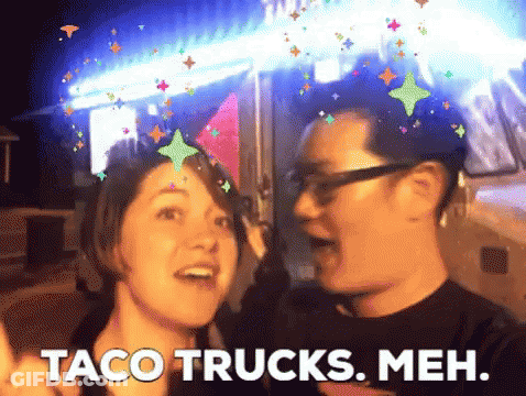 Man And Woman Standing Next To Taco Trucks Meh GIF