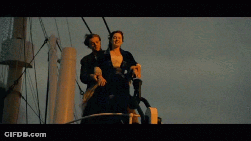 Man And Woman Standing On A Boat GIF