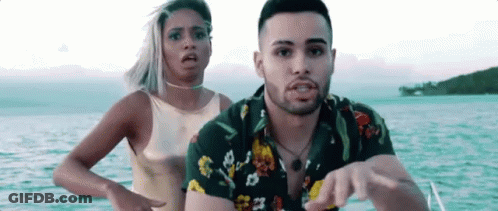 Man And Woman Standing On Boat In Ocean GIF