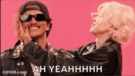 Man And Woman Standing On Pink Background Man Wearing Sunglasses GIF