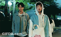 Man And Woman Standing On Sidewalk GIF