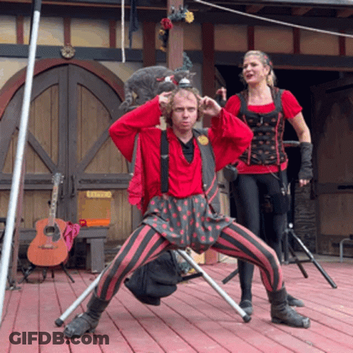 Man And Woman Standing On Stage With Catering Sign GIF