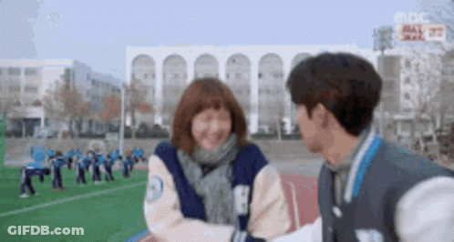 Man And Woman Standing Smiling On Field GIF