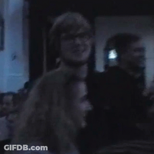 Man And Woman Standing Together In Dark Room GIF