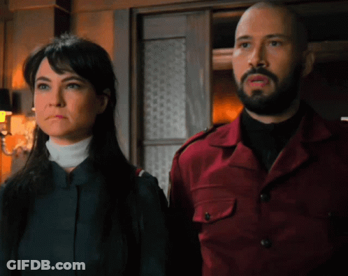 Man And Woman Standing Together Looking At Something GIF