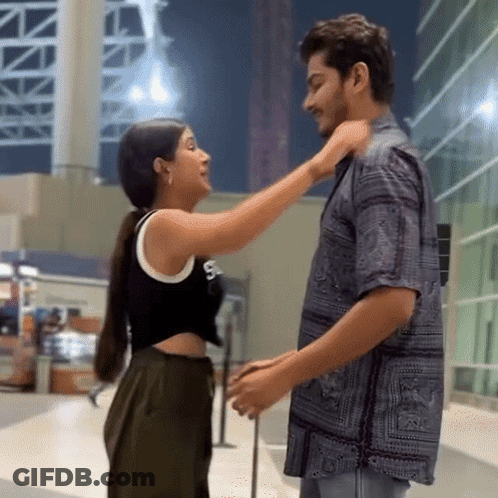 Man And Woman Standing Together With Hand On Neck GIF