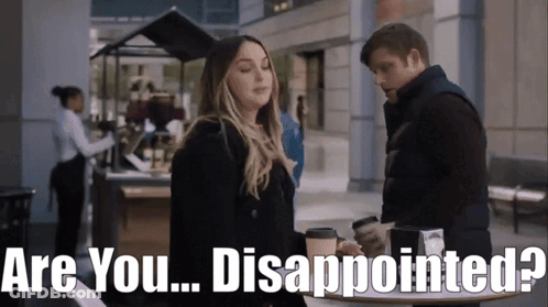 Man And Woman Standing With Are You Disappointed Behind Them GIF