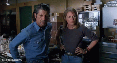 Man And Woman Standing With Hands On Hips GIF